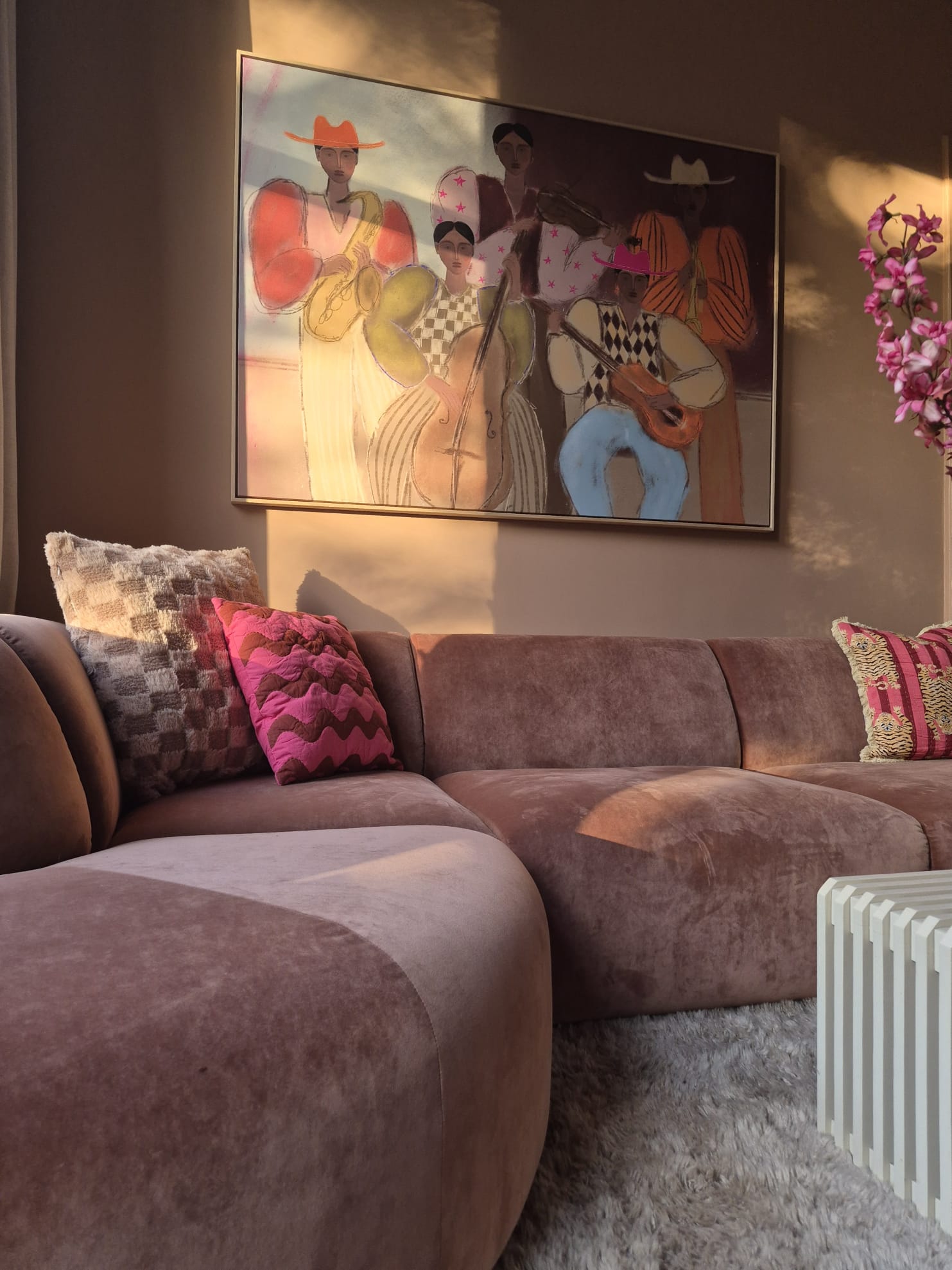 Roze velvet bank met kleurrijk schilderij